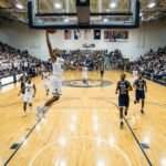 NCAA compliant home white and away dark basketball uniforms in a game.